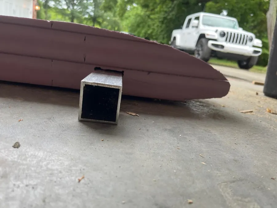 Aluminum beam inserted through a notch in a foam airfoil.