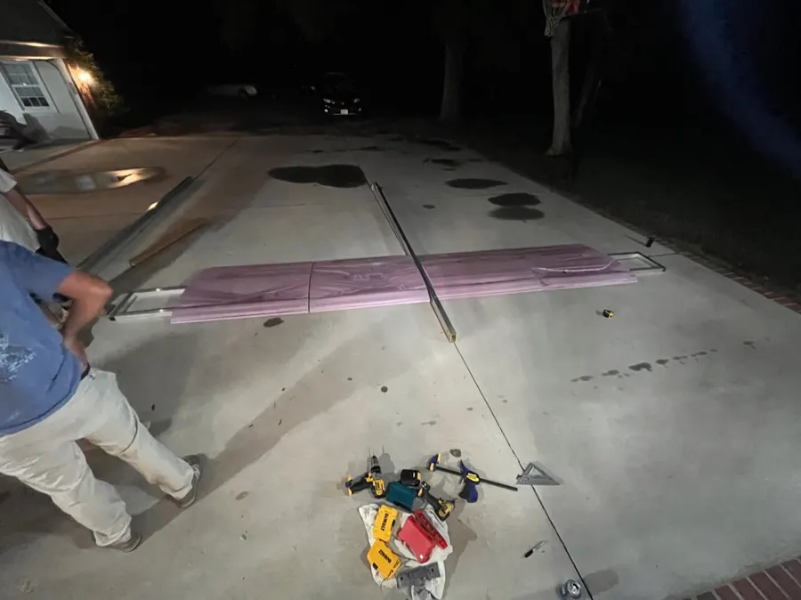 Several foam airfoils fitted onto the aluminum frame on a garage floor.